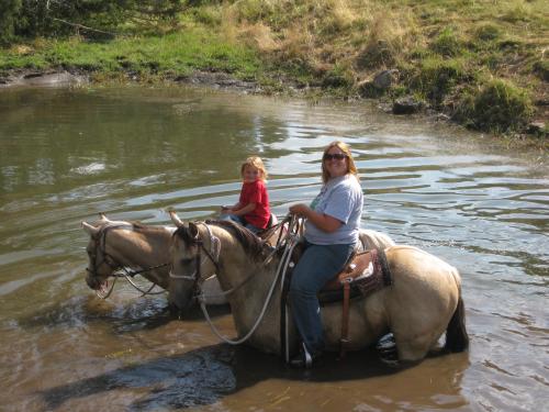 Dez and I swimming. I am riding another great ranch horse raised here sired by Dun with Chrome